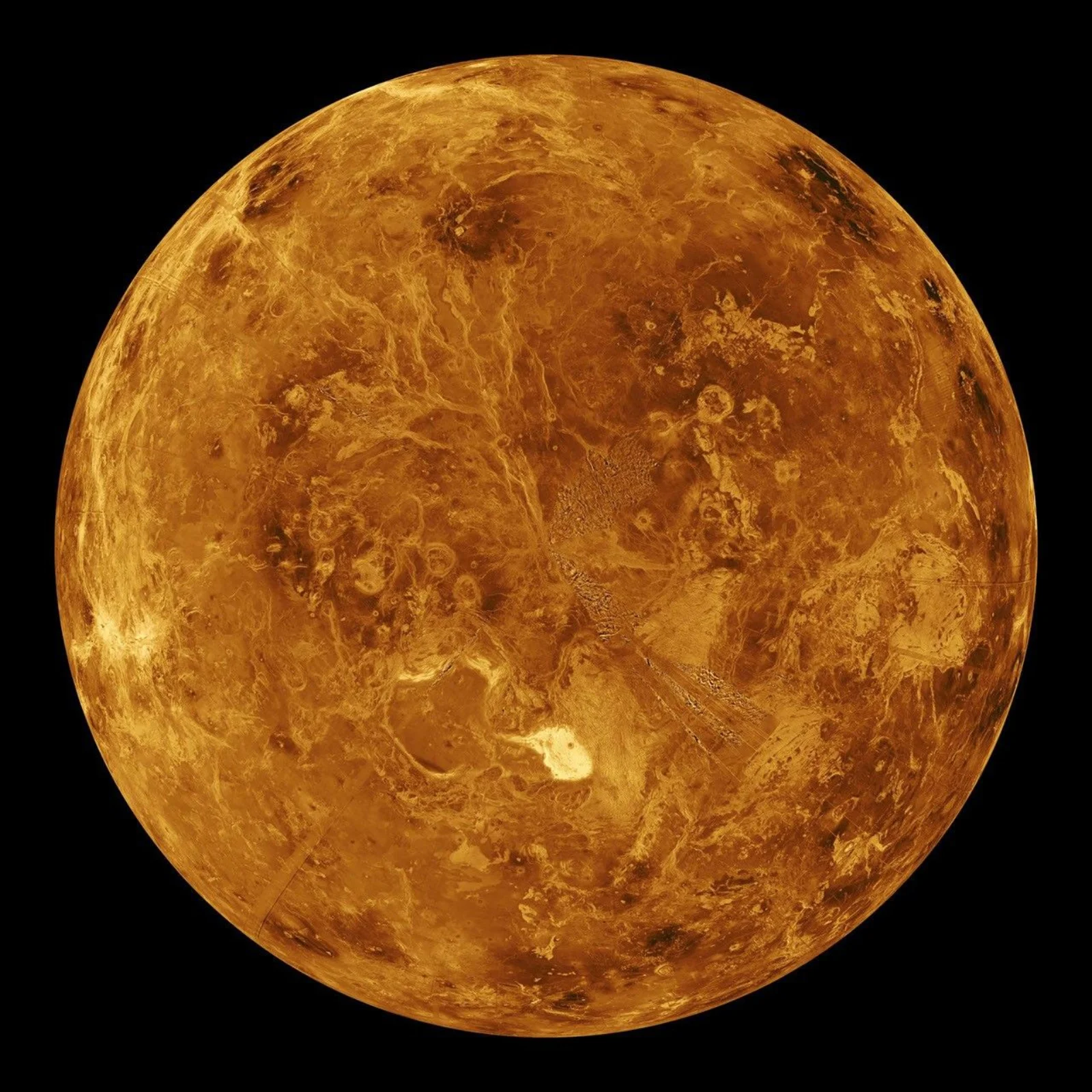 Magellan radar mosaic of Venus showing the northern hemisphere with volcanic plains, tesserae, and lava flows in orange-brown tones